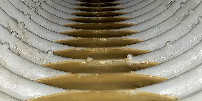 An invert of a corrugated metal pipe that has been coated in HydraLine epoxy to protect the invert of this culvert against corrosion