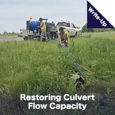 Field services crew members cleaning out a culvert with a jetter vac