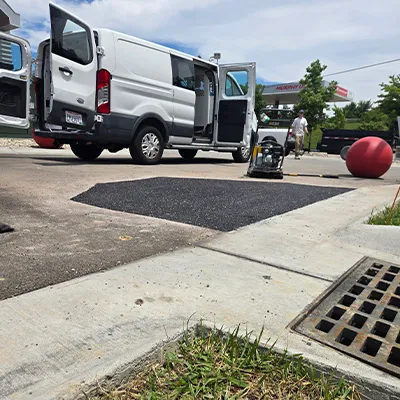 Pavement Patch Repair A patched portion concrete in a parking lot
