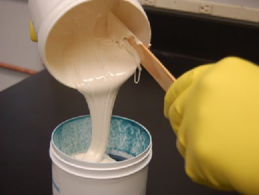 HydraLine components being mixed together by hand to create the epoxy
