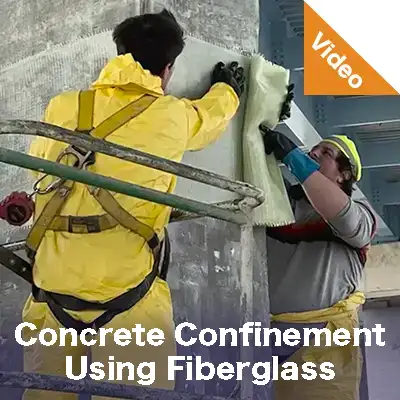 Two people in tyvek wrapping a column under a bridge in fiber wrap