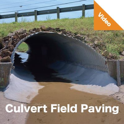 A corrugated metal pipe that has had its invert field paved with concrete