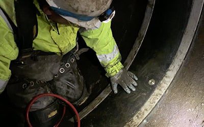 A technician installing HydraTite over a joint