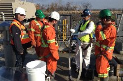 A hydratech technician explaining the HydraTite installation process while showing the trainees a retaining band