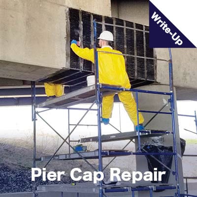 A pier cap under a bridge being wrapped by a technician in tyvek