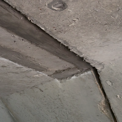 A portion of concrete under a bridge that has been patched