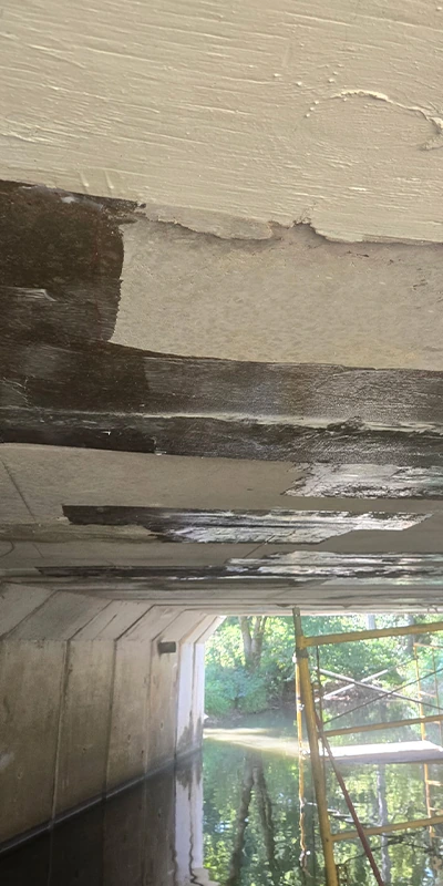 Epoxy that has been applied to the underside of a bridge