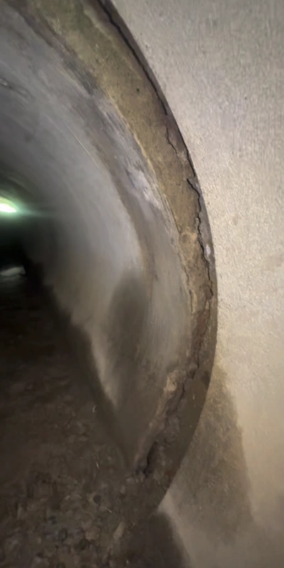 A separated pipe joint that has allowed debris to infiltrate the pipe and obstruct proper flow