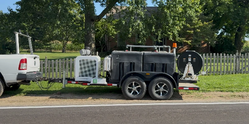 A jettervac system that is sitting on the side of a road