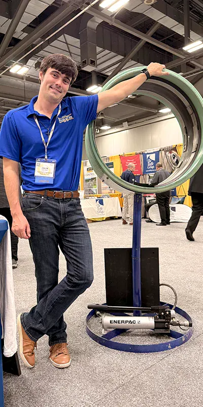 A HydraTech Engineered Products employee leaning on the HydraTite display