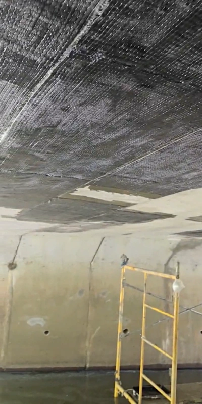 Fiber wrap fabric applied to portions of the underside of a bridge