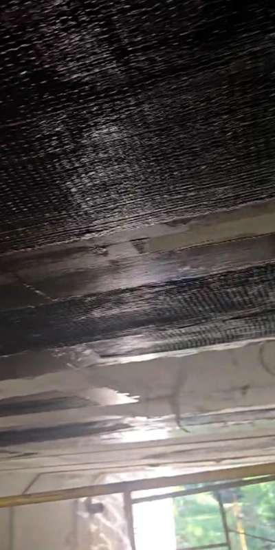 Fiber wrap fabric applied to portions of the underside of a bridge