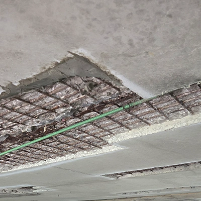 Portions of concrete removed from the underside of a bridge