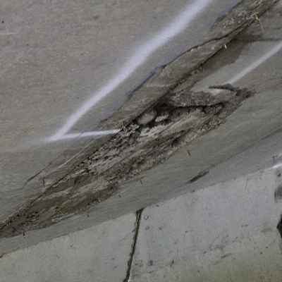 Portions of concrete removed from the underside of a bridge